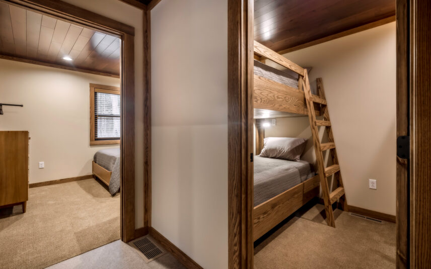 Bunk bed room in the ADA-accessible Cook Cabin at Gateway Lodge, Cook Forest State Park, Pennsylvania, featuring sturdy wooden bunk beds with individual reading lights, offering comfortable and accessible sleeping arrangements for families or groups.