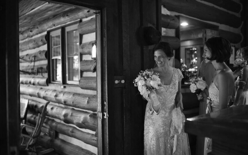 Black and white photo of smiling bride inside the rustic Gateway Lodge in Cook Forest, Pennsylvania.