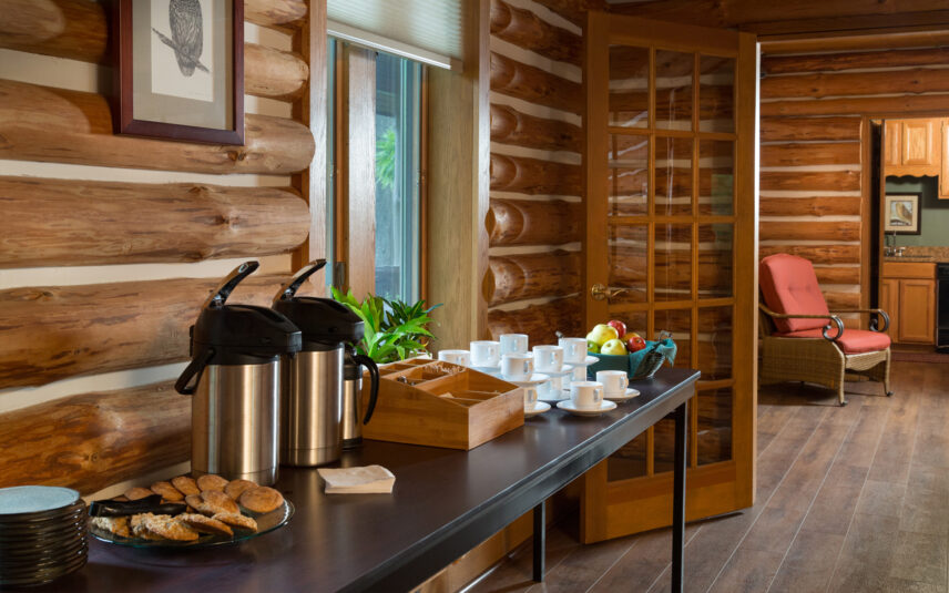 Food and coffee station at Gateway Lodge's Forest Meeting Facility in Cook Forest, Pennsylvania, attractively displaying fresh coffee, a variety of fresh-baked cookies, and a bowl of fresh fruit, perfect for group retreat refreshments.