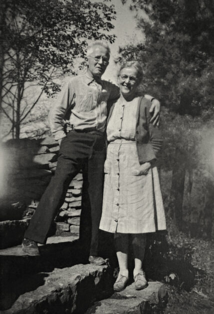 black and white image of the original owners of Gateway Lodge, Ray and Beth Griscom in 1947, standing on stone steps