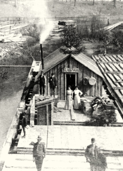 timber raft cooking shanty from the 1800s, traveling down the Clarion River, depicting women in long dresses and men in top hats standing