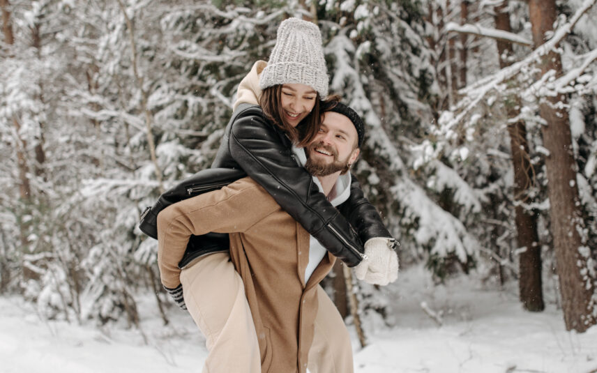 woman embracing a man in a winter forest