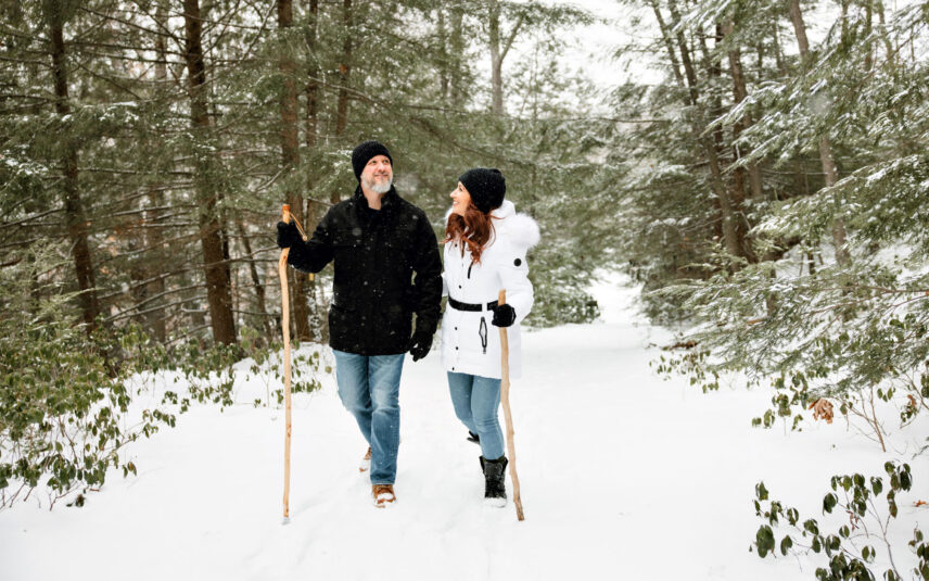 A couple hiking on a picturesque trail through the forest in Cook Forest State Park, Pennsylvania, enjoying a winter adventure near Gateway Lodge.